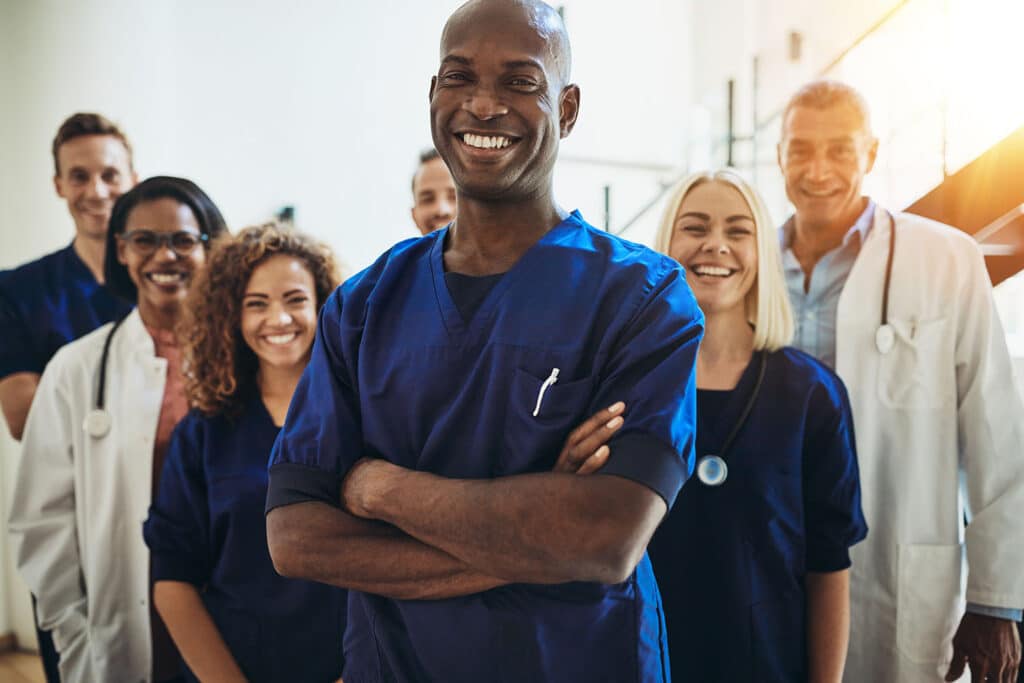 Doctor smiling while standing in a hospital