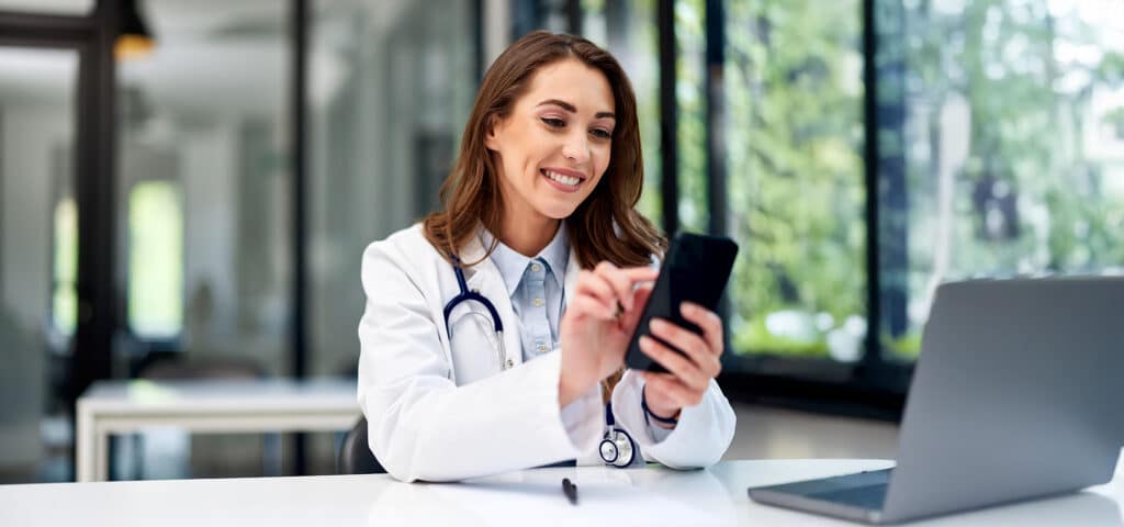 A female doctor using mobile phone.